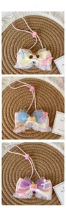 Detailed view of handmade pet bow ties with lace layers and cute cartoon animal charms