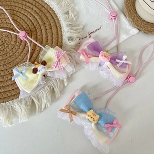 Detail of colorful organza pet bows with cute cartoon charms and adjustable pink straps