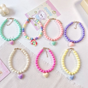 Detail of seven colorful beaded pet necklaces with heart pendants and lobster clasps