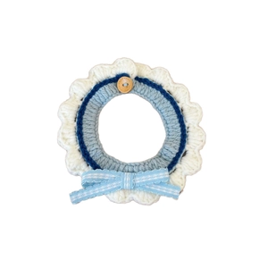 Handmade crochet pet collar with blue and white floral pattern and a checkered bow tie