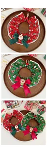 Detail of Christmas pet collar with silk bow and cartoon Santa on wooden tray