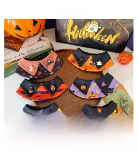 Detail of Halloween pet collars with pumpkin, ghost, and bat charms on a wooden tray