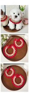 Detail of handmade tulip crochet pet scarf with red floral buds for cats and small dogs