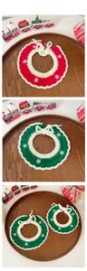 Detail of knitted Christmas pet scarves with white snowflakes and festive decorations