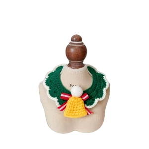 Handmade green crochet Christmas cat scarf with white trim, red bow, and yellow bell charm