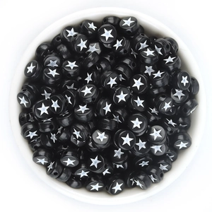 Close-up of black acrylic 7x4mm flat round star beads for DIY jewelry making