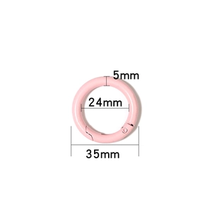 Close-up of a 35mm matte pink round spring O-ring buckle for bag strap adjustments