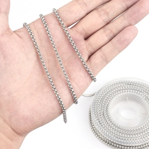 Macro shot of silver stainless steel box chain necklace showing link texture and width