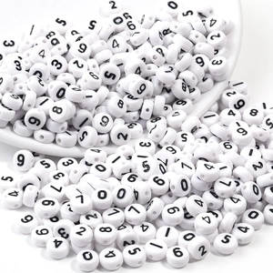 Macro shot of 7x4mm white acrylic number beads with black print for DIY jewelry crafts