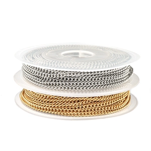 Detailed view of gold and silver curb chains on spools for DIY jewelry making