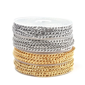 Detailed view of gold and silver stainless steel Cuban link chains on plastic spools