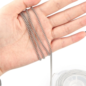 Macro detail of flexible 304 stainless steel curb chain links held in a hand