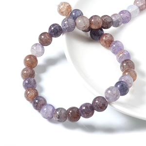 Perline di agata venata di drago lucide in viola e marrone su piatto ceramica