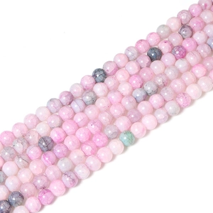 Dettaglio di perline tonde in vetro craquelé rosa e grigio per creazione gioielli