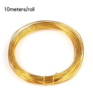 Close-up of 10m roll of golden aluminum wire for DIY jewelry making and crafting