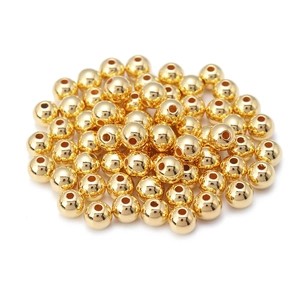 Macro-opname van gepolijste gouden CCB ronde kralen met middengat voor DIY-sieraden