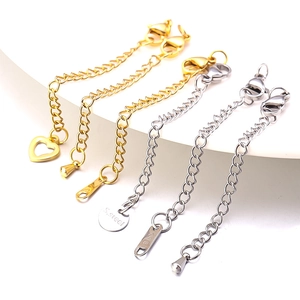 Macro view of stainless steel extender chains with lobster clasps and engraved S.steel charms
