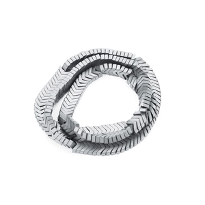Macro detail of matte dark grey hematite arrow-shaped beads in a coiled arrangement