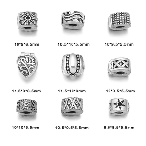 Set of nine antique silver charm beads with diverse relief patterns and 3D textures