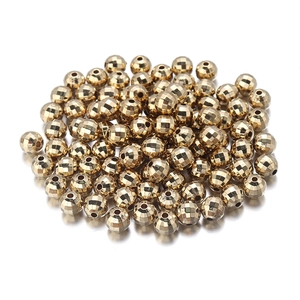 Close-up of golden faceted CCB beads with central holes for DIY jewelry making