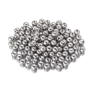 Close-up of faceted silver CCB beads with central holes for DIY jewelry making crafts