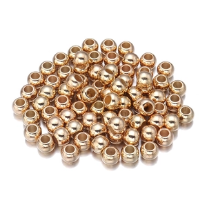 Macro view of polished gold-plated CCB spacer beads with center holes for DIY jewelry