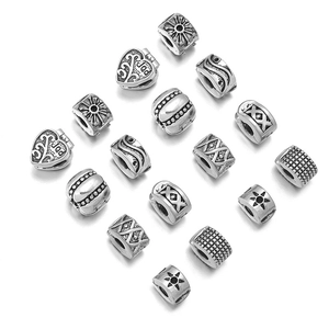 Macro view of vintage silver spacer beads with sunburst and geometric carvings