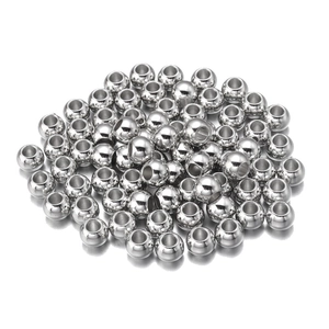 Close-up of polished silver CCB round spacer beads with large holes for DIY jewelry