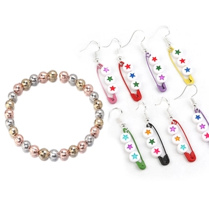 Detailed display of multifaceted CCB metal beads bracelet and colorful star safety pin earrings