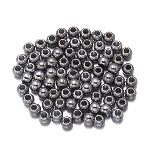 Macro detail of smooth metallic gunblack CCB round beads with center hole for DIY jewelry