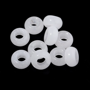 Macro shot of eleven translucent white stone large hole beads for DIY jewelry making
