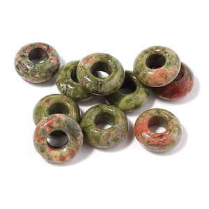 Macro view of natural unakite stone donut beads with polished finish for DIY jewelry