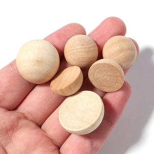 Close-up of natural unfinished semi-round wooden beads for DIY craft accessories