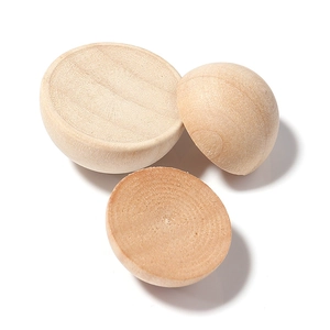 Three semi-spherical natural wood beads showing clear grain for DIY craft projects
