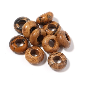 Macro detail of natural stone large hole spacer beads with brown leopard spots
