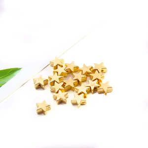 Star-shaped golden metal spacers for DIY jewelry making in polished finish