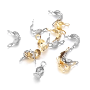 Detailed macro view of gold and silver stainless steel calotte ends for jewelry making