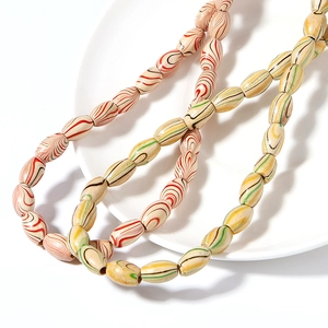 Macro shot of oval wooden beads with colorful water ripple patterns for DIY jewelry