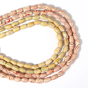 Detailed view of layered olive-shaped beads with marbled flowing patterns for DIY jewelry