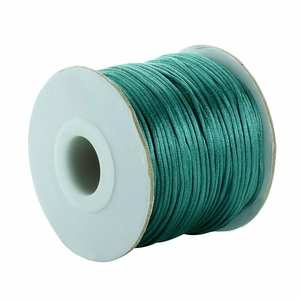 Close-up of tiffany blue silk cord spool for DIY jewelry making and handmade weaving