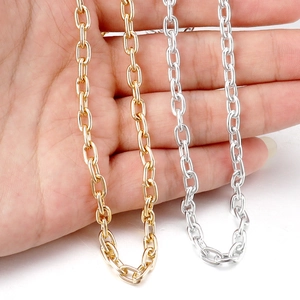 Close-up of gold and silver aluminum O-chains held in hand to show size and texture
