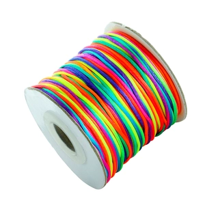 Detailed view of multi-color gradient silk cord spool for DIY jewelry weaving crafts