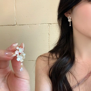 Detailed view of French style zircon floral tassel earrings with elegant shimmering petal details