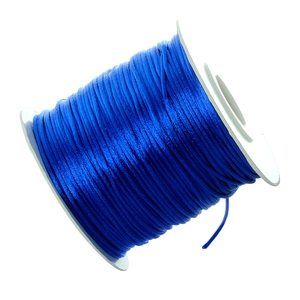 Macro view of sapphire blue silk satin cord roll for jewelry making and DIY weaving