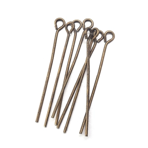 Macro view of bronze metal eye pins for DIY jewelry making and beaded connectors