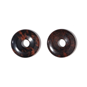 Macro detail of natural mahogany obsidian donut charms with polished brown and black texture