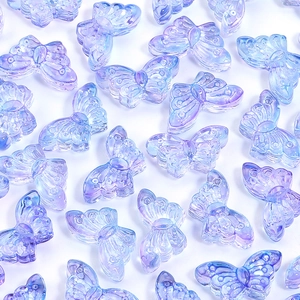 Macro view of blue-purple gradient glass butterfly beads with iridescent coating