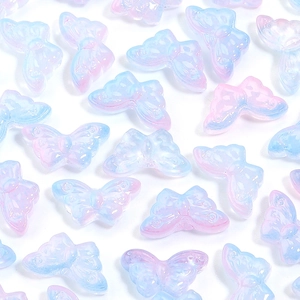 Macro detail of gradient butterfly beads with AB coating and embossed wing textures