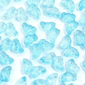 Macro shot of light blue translucent butterfly beads with fine glitter texture