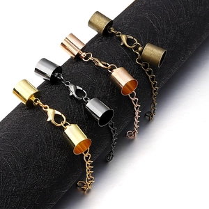 Detailed macro view of lobster clasps with end caps and extension chains in four metal colors